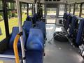 Interior view of a 2020 Chevrolet Express with blue seats and a spare tire secured on the floor