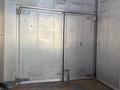A pair of metallic doors with hinges and a latch, designed for the cargo area of a 2011 Freightliner M2 106 truck