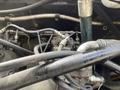 A close-up view of the engine components of a 2018 John Deere 350 featuring various metal pipes and fittings