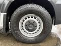 Close-up of a 2017 Mercedes-Benz Sprinter wheel featuring a Yokohama tire with a distinctive tread pattern and the Mercedes-Benz logo on the hubcap