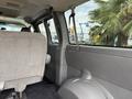 Interior view of a 2004 Chevrolet Express with gray upholstery showing rear seats and seatbelt attachments
