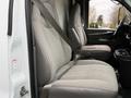 Interior of a 2008 Chevrolet Express showing two front seats with seatbelts secured in place