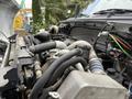 Close-up view of a 2019 Ford F-750 engine showcasing various hoses and components including a radiator hose and coolant lines