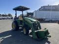 A green 2008 John Deere 3320 tractor with wide wheels and a front loader attachment