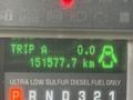 The image shows a digital display panel of a 2010 Ford F-550 with trip information and fuel specifications indicating a total distance of 151577.7 km