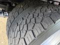 Close-up of the tire tread of a 2020 Ford F-550 showcasing deep grooves and robust patterns designed for traction and durability