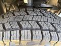 Close-up view of a tire tread from a 2024 Mercedes-Benz Sprinter 2500 showcasing deep grooves for traction and a rugged design