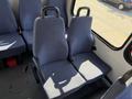 Two blue upholstered seats with armrests positioned side by side in the interior of a vehicle