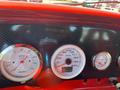 Dashboard of a 1962 Ford 2WHDR featuring three gauges showing RPM speed and temperature with a carbon fiber design throughout