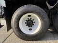 A close-up of a tire mounted on a 2011 International 7500 truck featuring the GoodYear brand with visible tread patterns and a white rim
