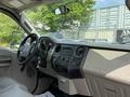 Interior of a 2008 Ford F-250 SD with a dashboard featuring controls and a steering wheel with keys in the ignition