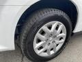 A close-up of a silver wheel from a 2014 RAM Cargo Van featuring a multi-spoke design and a rugged tire with noticeable tread patterns