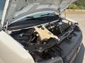 A 2021 Chevrolet Express with its hood raised revealing the engine compartment and various components inside