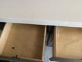 A view of two empty wooden drawers without any contents visible