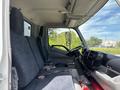 Interior of a 2018 Hino 195 showing two front seats with dark upholstery and a driver’s seat positioned near the dashboard and controls