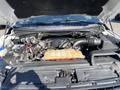 The image shows the open hood of a 2018 Ford F-150 revealing the engine compartment with visible components like the engine block battery and coolant reservoir