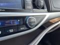 The image shows the climate control interface of a 2018 Toyota Highlander featuring buttons for temperature adjustment and air conditioning settings