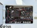 An open electrical panel showing multiple fuses wires and connections inside a 2009 International 3000 CE vehicle