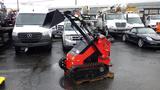 A red 2023 AGT Industrial compact track loader with a front bucket and tracks for mobility standing on a wooden pallet