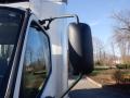 Side mirror of a 2015 Hino 195 truck mounted on the driver's side with a sleek black cover