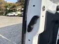A close-up view of the door latch mechanism on a 2016 Ford Transit 150 showing the handle and locking mechanism