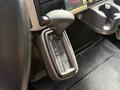 The gear shift lever of a 2011 International 4300 with indicators for park reverse neutral and drive
