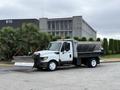 A 2012 International TerraStar truck equipped with a salt spreader and a snow plow attached to the front