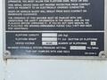 2005 Freightliner M2 106 truck with a metallic nameplate displaying specifications and safety information