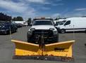 A white 2016 RAM 5500 truck equipped with a yellow Meyer snow plow attachment in the foreground