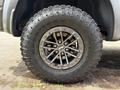 A close-up of a 2019 Ford F-150 wheel featuring a black metal rim and a rugged Goodyear Wrangler tire with deep tread for off-road performance