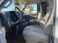 Interior view of a 2016 GMC Savana showing the driver and passenger seats with a steering wheel and dashboard in focus