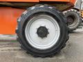 Close-up of a black tire on a 2012 JLG 660SJ with a white rim and logo visible on the hub
