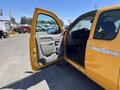 A yellow 2013 Chevrolet Silverado 1500 with an open driver's door revealing a spacious interior and dashboard