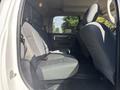 Interior view of a 2014 RAM 5500 cab showing the back seats with gray fabric upholstery and a spacious seating area
