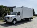 A 2018 Ford E-450 box truck in white parked with a clean exterior and no visible cargo in the back