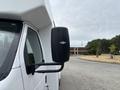 2014 Ford E-350 side mirror with a black casing and reflective surface