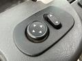 Close-up of controls on the interior dashboard of a 2016 International 7600 featuring directional buttons and a round knob with arrow indicators