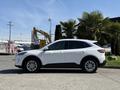 A white 2020 Ford Escape SUV parked with a side view showcasing its sleek design and wheel detail