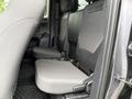Interior view of a 2016 Toyota Tacoma with rear seats folded up revealing storage space