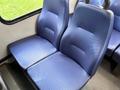 Two blue fabric seats inside a vehicle with a simple design and textured surface