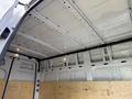 Interior of a 2022 Mercedes-Benz Sprinter van showing a spacious cargo area with a white ceiling and wooden panels on the sides