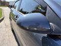 A close-up of the side mirror of a 2018 Kia Rio5 showcasing its sleek design and glossy finish