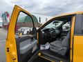 A 2014 Ford F-150 with an open driver's side door showing a gray interior and steering wheel