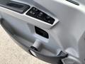 A close-up of the door panel of a 2020 Lion Lion6 featuring control buttons and a textured surface