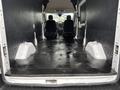 A 2020 Ford Transit 250 with a spacious empty cargo area featuring a black floor and two front seats visible at the back