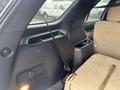Interior view of a 2016 Ford Explorer showing a seat, armrest, and storage compartments with a seatbelt secured in place