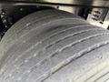 Close-up of a large tire on a 2019 Ford F-750 showing worn tread patterns and robust rubber design