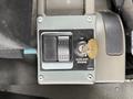 Control panel for the auxiliary engine of a 2009 UD Trucks UD 3300 featuring a start button a shutdown override button and a key slot