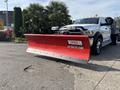 A 2013 RAM 5500 truck with a red snow plow attached to the front displaying the text WESTERN CONTRACTOR GRADE
