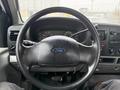 Steering wheel of a 2006 Ford F-450 with controls and dashboard instruments visible